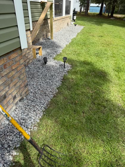 Gravel drain along a foundation at the deck posts