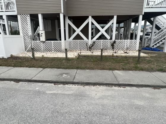 Gravel strip beneath a raised beach house