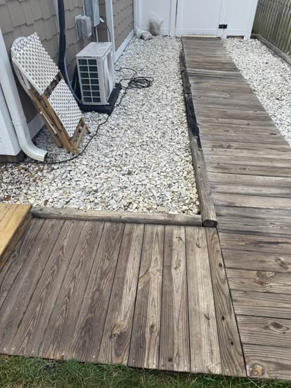 Gravel and wood walkway to the AC unit