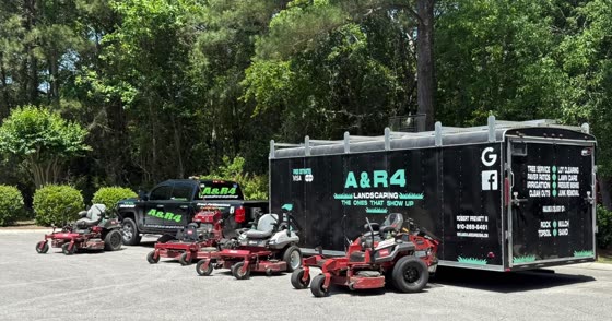 Zero-turn mowers lined up at the trailer