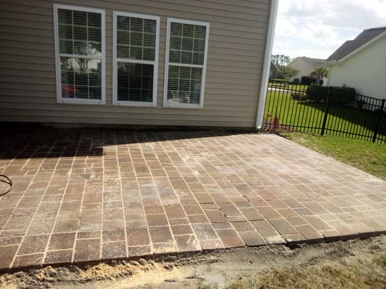 Paver patio behind a home