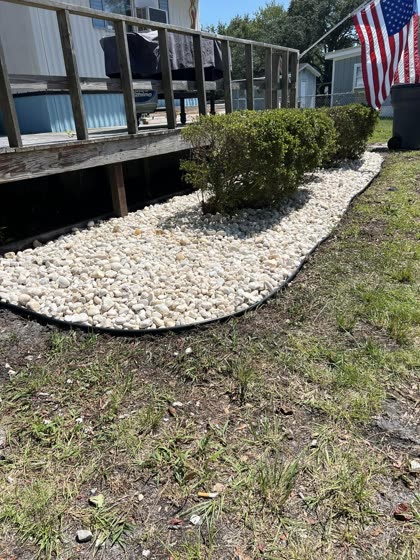 White rock bed along deck steps