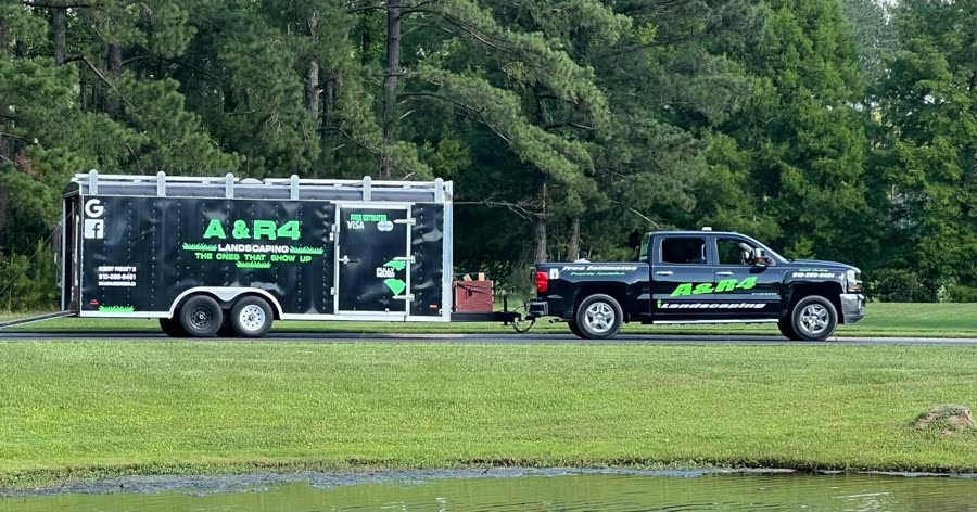 The A & R4 Landscaping truck and enclosed trailer on a lawn