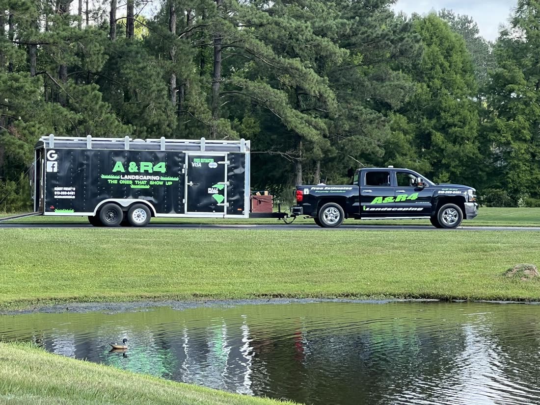Truck and trailer by a pond on a job