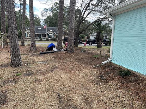 Yard cleanup and grading beside a home